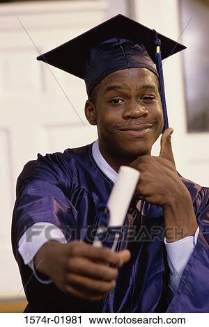 Portrait of a teenage boy showing a thumbs up sign with a graduation degree in hand View Large Photo Image Stock Image - Portrait of a teenage boy showing a thumbs up sign with a graduation degree in hand. Fotosearch