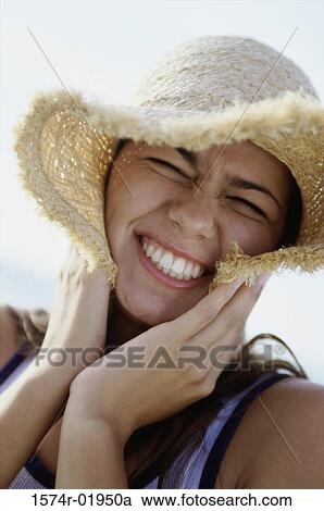 Portrait of a teenage girl wearing a straw hat smiling View Large Photo Image Stock Image - Portrait of a teenage girl wearing a straw hat smiling. Fotosearch