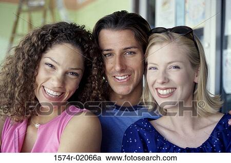 Portrait of a young man with two young women View Large Photo Image Stock Image - Portrait of a young man with two young women. Fotosearch