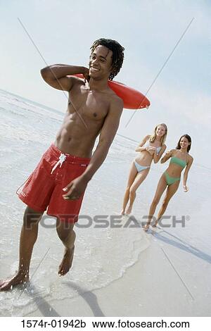 Teenage boy holding a float with two teenage girls behind him View Large Photo Image Stock Image - Teenage boy holding a float with two teenage girls behind him. Fotosearch