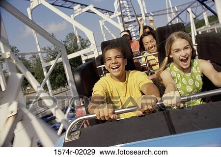 Teenage couple on a roller coaster ride View Large Photo Image Stock Photo - Teenage couple on a roller coaster ride. Fotosearch