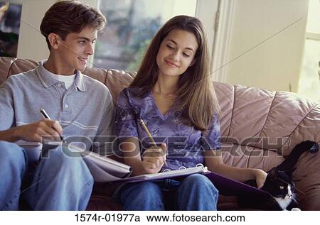 Stock Image - Teenage couple sitting together on a couch. Fotosearch