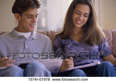 Stock Photo - Teenage couple sitting together on a couch. Fotosearch