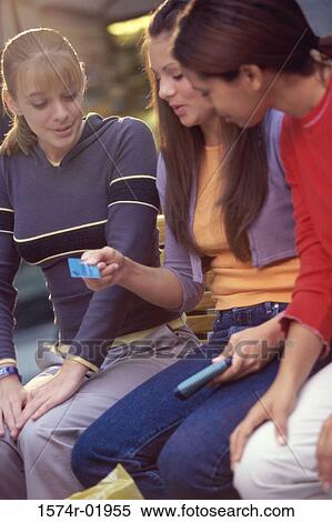 Teenage girl holding a credit card View Large Photo Image Stock Photography - Teenage girl holding a credit card. Fotosearch