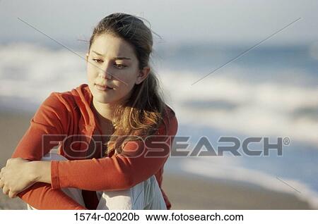 Teenage girl sitting at the beach View Large Photo Image Stock Image - Teenage girl sitting at the beach. Fotosearch