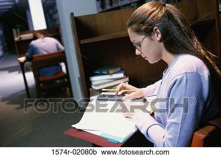 Teenage girl studying in a library View Large Photo Image Stock Image - Teenage girl studying in a library. Fotosearch