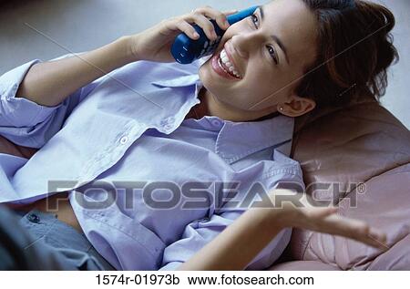 Teenage girl talking on a telephone View Large Photo Image Stock Image - Teenage girl talking on a telephone. Fotosearch