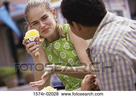 Teenagers eating ice cream View Large Photo Image Stock Photo - Teenagers eating ice cream. Fotosearch