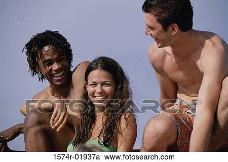 Three teenagers sitting at the beach View Large Photo Image Stock Image - Three teenagers sitting at the beach. Fotosearch