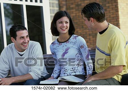 Three teenagers talking to each other View Large Photo Image Stock Image - Three teenagers talking to each other. Fotosearch