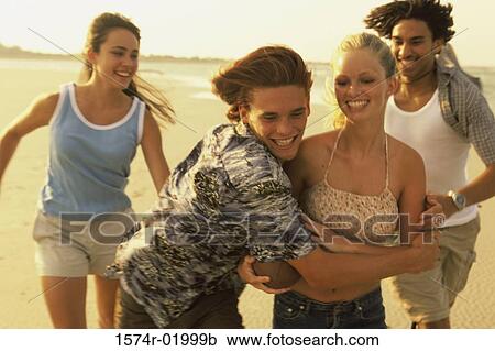 Two teenage couples at the beach View Large Photo Image Stock Image - Two teenage couples at the beach. Fotosearch