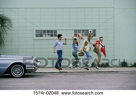 Stock Photo - Two young couples doing the conga on a sidewalk. Fotosearch