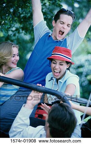 Two young couples sitting in a car View Large Photo Image Stock Photo - Two young couples sitting in a car. Fotosearch