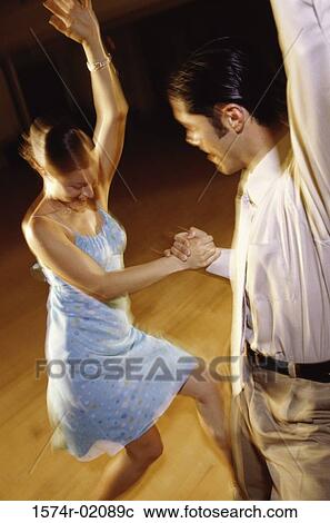 Stock Image - Young couple dancing together. Fotosearch