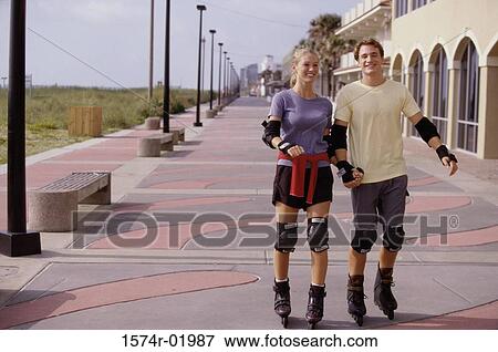 Young couple in-line skating View Large Photo Image Stock Photo - Young couple in-line skating. Fotosearch