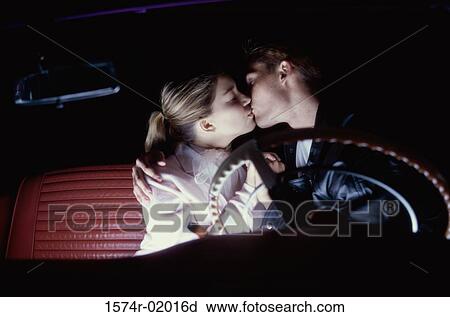 Young couple kissing in a car View Large Photo Image Stock Image - Young couple kissing in a car. Fotosearch