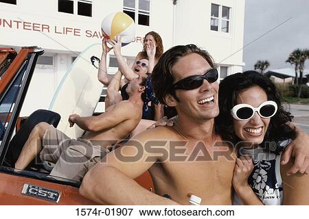Young men and women in a car with surfboards View Large Photo Image Stock Photo - Young men and women in a car with surfboards. Fotosearch