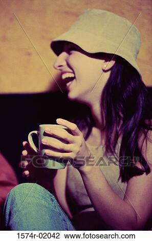 Young woman drinking a cup of coffee View Large Photo Image Stock Image - Young woman drinking a cup of coffee. Fotosearch