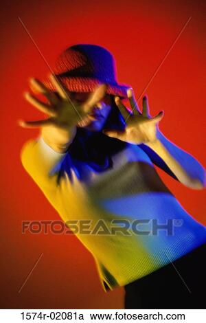 Stock Image - Young woman shielding her face. Fotosearch