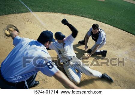 Picture - Baseball player sliding into home base. Fotosearch