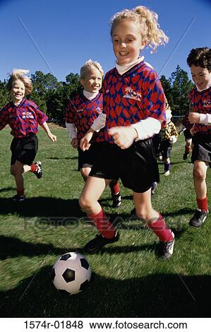 Stock Photo - Children playing soccer. Fotosearch