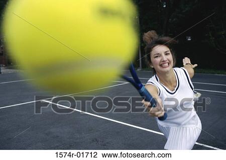 Stock Image - Close-up of a young woman playing tennis. Fotosearch