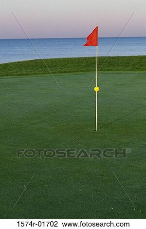 Stock Image - Flag on a golf course. Fotosearch