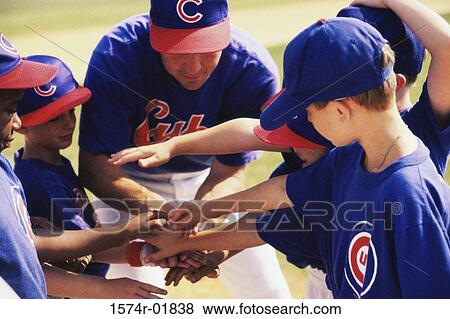 Stock Photo - Little league baseball team in a huddle. Fotosearch