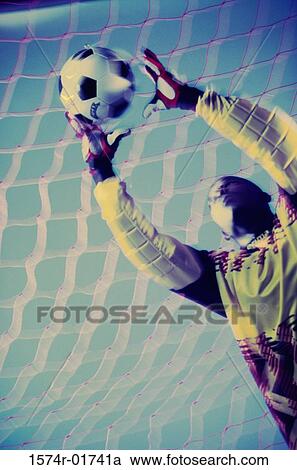 Low angle view of a goalie catching a ball View Large Photo Image Stock Image - Low angle view of a goalie catching a ball. Fotosearch