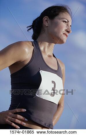Low angle view of a woman standing with her hands on her hips View Large Photo Image Stock Photography - Low angle view of a woman standing with her hands on her hips. Fotosearch
