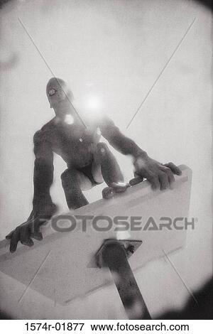Stock Photo - Low angle view of a young man on a diving board. Fotosearch