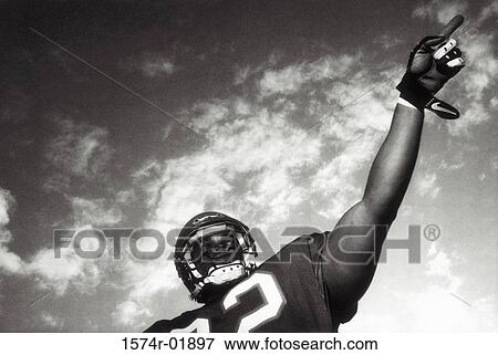 Stock Photo - Low angle view of an American football player. Fotosearch
