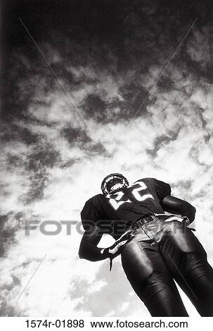 Stock Photo - Low angle view of an American football player. Fotosearch