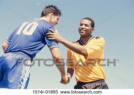 Low angle view of two soccer players shaking hands View Large Photo Image Stock Image - Low angle view of two soccer players shaking hands. Fotosearch