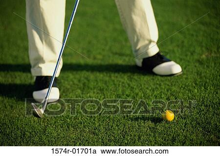 Stock Image - Low section view of a person playing golf. Fotosearch