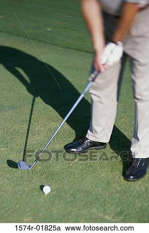 Stock Image - Low section view of a person playing golf. Fotosearch