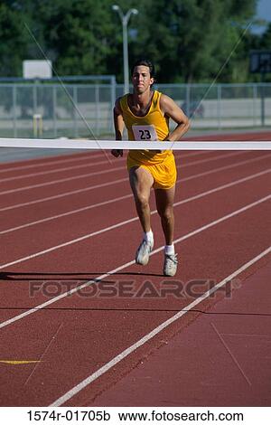 Male runner crossing a finishing line View Large Photo Image Stock Image - Male runner crossing a finishing line. Fotosearch