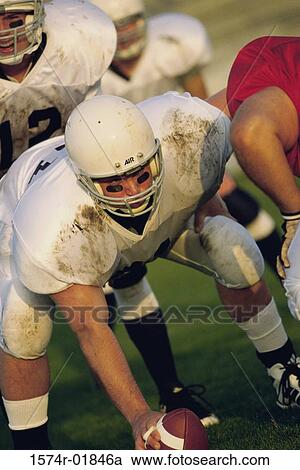 Stock Image - Men playing American football. Fotosearch