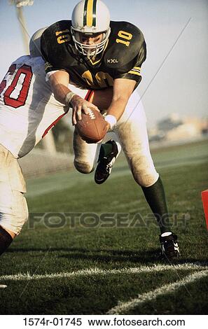 Stock Photography - Men playing American football. Fotosearch
