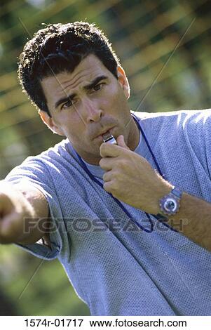 Portrait of a coach blowing a whistle View Large Photo Image Stock Photo - Portrait of a coach blowing a whistle. Fotosearch