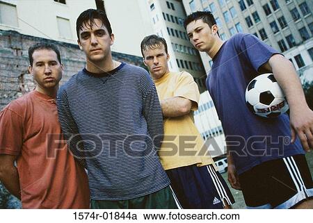 Stock Image - Portrait of a group of young men playing soccer. Fotosearch