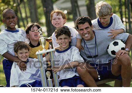 Stock Image - Portrait of a soccer team and coach with a trophy. Fotosearch