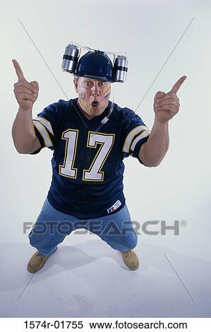 Stock Photography - Portrait of a sports fan holding his fingers up. Fotosearch