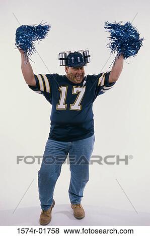 Portrait of a sports fan holding pom-pom in his hands View Large Photo Image Stock Photo - Portrait of a sports fan holding pom-pom in his hands. Fotosearch