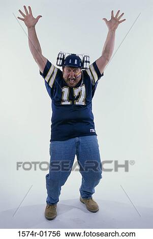 Portrait of a sports fan with his arms raised View Large Photo Image Stock Photograph - Portrait of a sports fan with his arms raised. Fotosearch