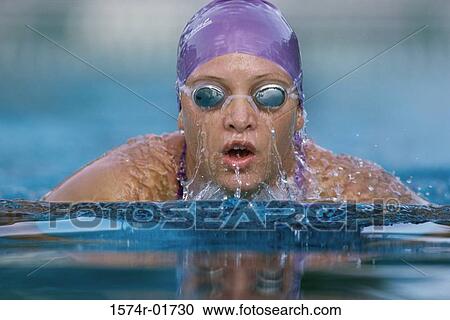 Portrait of a woman swimming in a swimming pool View Large Photo Image Stock Image - Portrait of a woman swimming in a swimming pool. Fotosearch