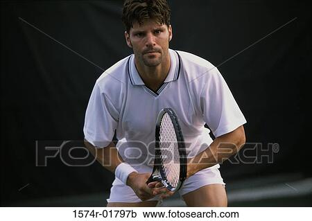 Portrait of a young man playing tennis View Large Photo Image Stock Image - Portrait of a young man playing tennis. Fotosearch