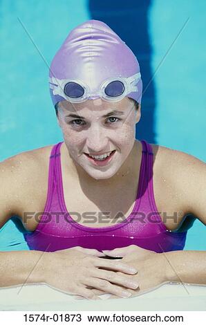 Stock Image - Portrait of a young woman standing in a swimming pool. Fotosearch