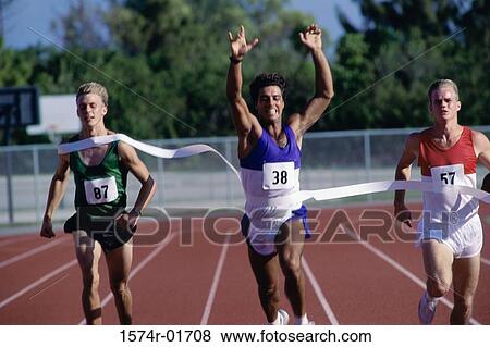 Stock Photo - Portrait of male runners crossing the finishing line in a race. Fotosearch