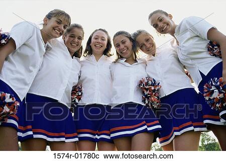 Stock Image - Portrait of teenage girls in uniform with pom-poms. Fotosearch